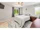 Cozy bedroom with natural light, a ceiling fan, and wood-look flooring at 18672 E Chaffee Pl, Denver, CO 80249