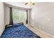 Bedroom with a ceiling fan, window, door and plush bed with a blue comforter at 18672 E Chaffee Pl, Denver, CO 80249