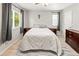 Comfortable bedroom with two windows, wood-look floors, and a ceiling fan at 18672 E Chaffee Pl, Denver, CO 80249