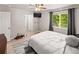 Well-lit bedroom features wood-look floors, ceiling fan, and ample natural light from the window at 18672 E Chaffee Pl, Denver, CO 80249