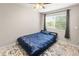 Bedroom with a ceiling fan, window and plush bed with a blue comforter at 18672 E Chaffee Pl, Denver, CO 80249