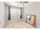 Bedroom with a ceiling fan, window, mirror and door at 18672 E Chaffee Pl, Denver, CO 80249