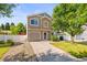 Two-story home featuring a well-kept lawn, driveway, and attractive exterior at 18672 E Chaffee Pl, Denver, CO 80249