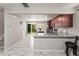 Open kitchen boasts granite countertops, stainless appliances, and views of the backyard at 18672 E Chaffee Pl, Denver, CO 80249