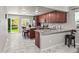 Modern kitchen with granite countertops, stainless steel appliances, and island with bar stool seating at 18672 E Chaffee Pl, Denver, CO 80249