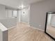 Neutral loft with wood-look floors, recessed lighting, and multiple entryways to bedrooms at 18672 E Chaffee Pl, Denver, CO 80249
