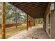 Expansive stone patio with wooden supports, offering ample space for outdoor relaxation and enjoyment of the natural surroundings at 459 Virginia Ave, Palmer Lake, CO 80133