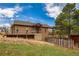 Home exterior featuring a well-maintained lawn, landscaping, and a charming ski fence at 459 Virginia Ave, Palmer Lake, CO 80133