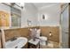 Bathroom featuring a vanity, toilet, patterned tiles, and stylish fixtures at 459 Virginia Ave, Palmer Lake, CO 80133