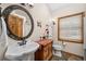 Charming bathroom features a decorative vanity with vessel sink, round mirror, and traditional-style fixtures at 459 Virginia Ave, Palmer Lake, CO 80133