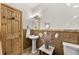 Bathroom featuring a vanity, toilet, patterned tiles, and stylish fixtures at 459 Virginia Ave, Palmer Lake, CO 80133