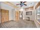 Bright bedroom featuring carpet, ceiling fan, wood trim, and natural light at 459 Virginia Ave, Palmer Lake, CO 80133