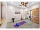 Bedroom featuring carpet flooring, neutral walls, large window and a wood door at 459 Virginia Ave, Palmer Lake, CO 80133