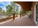 Inviting deck with wood-like flooring, metal railing, and a lovely view of the surrounding landscape at 459 Virginia Ave, Palmer Lake, CO 80133