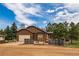 Well-kept home featuring an attached garage and manicured lawn, offering comfortable suburban living at its finest at 459 Virginia Ave, Palmer Lake, CO 80133