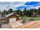 Charming single-story home with a two-car garage and surrounded by lush trees at 459 Virginia Ave, Palmer Lake, CO 80133
