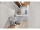 Laundry area featuring a sink, washer, dryer, and storage shelves at 459 Virginia Ave, Palmer Lake, CO 80133