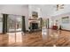 Bright living room featuring a fireplace, wood floors, and sliding door with access to the deck at 459 Virginia Ave, Palmer Lake, CO 80133