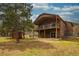 A view of the rear exterior of the home, featuring a balcony and patio, seamlessly blending indoor and outdoor living at 459 Virginia Ave, Palmer Lake, CO 80133