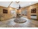 Stylish recreation room with tiled floors, wood-paneled walls, and patio access at 459 Virginia Ave, Palmer Lake, CO 80133