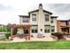 Two-story home featuring a backyard patio and garden at 15160 W Iliff Pl, Lakewood, CO 80228