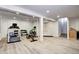 Finished basement featuring exercise equipment and light wood-look flooring at 15160 W Iliff Pl, Lakewood, CO 80228