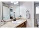 Bright bathroom with a light countertop, stylish sink, and a well-lit mirror at 15160 W Iliff Pl, Lakewood, CO 80228