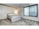 Finished basement bedroom with a bright window and plush carpet flooring at 15160 W Iliff Pl, Lakewood, CO 80228