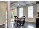 Dining area with lots of natural light, stylish light fixture, and access to the backyard at 15160 W Iliff Pl, Lakewood, CO 80228