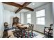 Charming dining room with wooden beams, classic furniture, and natural light, perfect for Gathering gatherings at 15160 W Iliff Pl, Lakewood, CO 80228