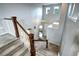 Grand two-story foyer with a beautiful staircase and chandelier, creating an inviting entrance at 15160 W Iliff Pl, Lakewood, CO 80228