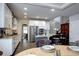 Spacious kitchen with white cabinets, granite countertops, stainless steel appliances, and a breakfast nook at 15160 W Iliff Pl, Lakewood, CO 80228