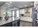 Gourmet kitchen featuring a large island, granite countertops, and stainless steel appliances at 15160 W Iliff Pl, Lakewood, CO 80228