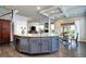 Modern kitchen with granite countertops, white cabinets, stainless steel appliances, and breakfast table at 15160 W Iliff Pl, Lakewood, CO 80228
