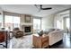 Cozy living room featuring hardwood floors, a stone fireplace, and a comfortable seating area at 15160 W Iliff Pl, Lakewood, CO 80228