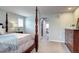 Another view of the spacious main bedroom with a four-poster bed, sitting area, and ample natural light at 15160 W Iliff Pl, Lakewood, CO 80228