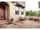 Inviting patio with brick pavers, comfortable seating and beautiful flower pot at 15160 W Iliff Pl, Lakewood, CO 80228