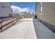 Concrete driveway leading to the back with a wood fence and nice landscaping at 5128 Preserve Pl, Firestone, CO 80504