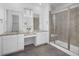 Bright bathroom featuring double vanity sinks, granite countertops, glass shower and ceramic tile flooring at 5128 Preserve Pl, Firestone, CO 80504