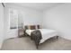 Bright bedroom with a large bed and neutral decor, next to a bright window with blinds at 5128 Preserve Pl, Firestone, CO 80504