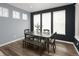 Dining room featuring a dark wood table, bench seating, large windows, and hardwood floors at 5128 Preserve Pl, Firestone, CO 80504