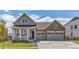 Charming two-story home featuring a covered porch, two-car garage, and well-maintained lawn at 5128 Preserve Pl, Firestone, CO 80504