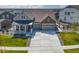 Aerial view of the charming two-story home featuring a well-manicured lawn and two-car garage at 5128 Preserve Pl, Firestone, CO 80504