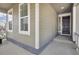 Inviting front porch featuring ample lighting and a decorative front door at 5128 Preserve Pl, Firestone, CO 80504