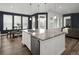 Modern kitchen with granite island, stainless steel appliances, and hardwood floors, creating an open, inviting space at 5128 Preserve Pl, Firestone, CO 80504
