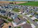 Aerial view of the neighborhood showcasing houses with solar panels and well-maintained lawns at 5128 Preserve Pl, Firestone, CO 80504