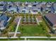 Aerial view of a neighborhood park with green spaces, trees, and sidewalks at 5128 Preserve Pl, Firestone, CO 80504