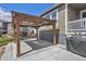 This backyard features a stylish pergola with overhead lighting and a fenced-in yard at 5128 Preserve Pl, Firestone, CO 80504