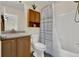 Cozy bathroom with a shower-tub combination, oak vanity, and functional storage cabinet at 165 Montgomery Dr, Erie, CO 80516