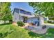 Charming two-story home with blue siding, landscaped front yard, and inviting curb appeal at 165 Montgomery Dr, Erie, CO 80516